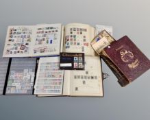 A box containing stamp albums of world stamps, a small quantity of coins, commemorative crown,