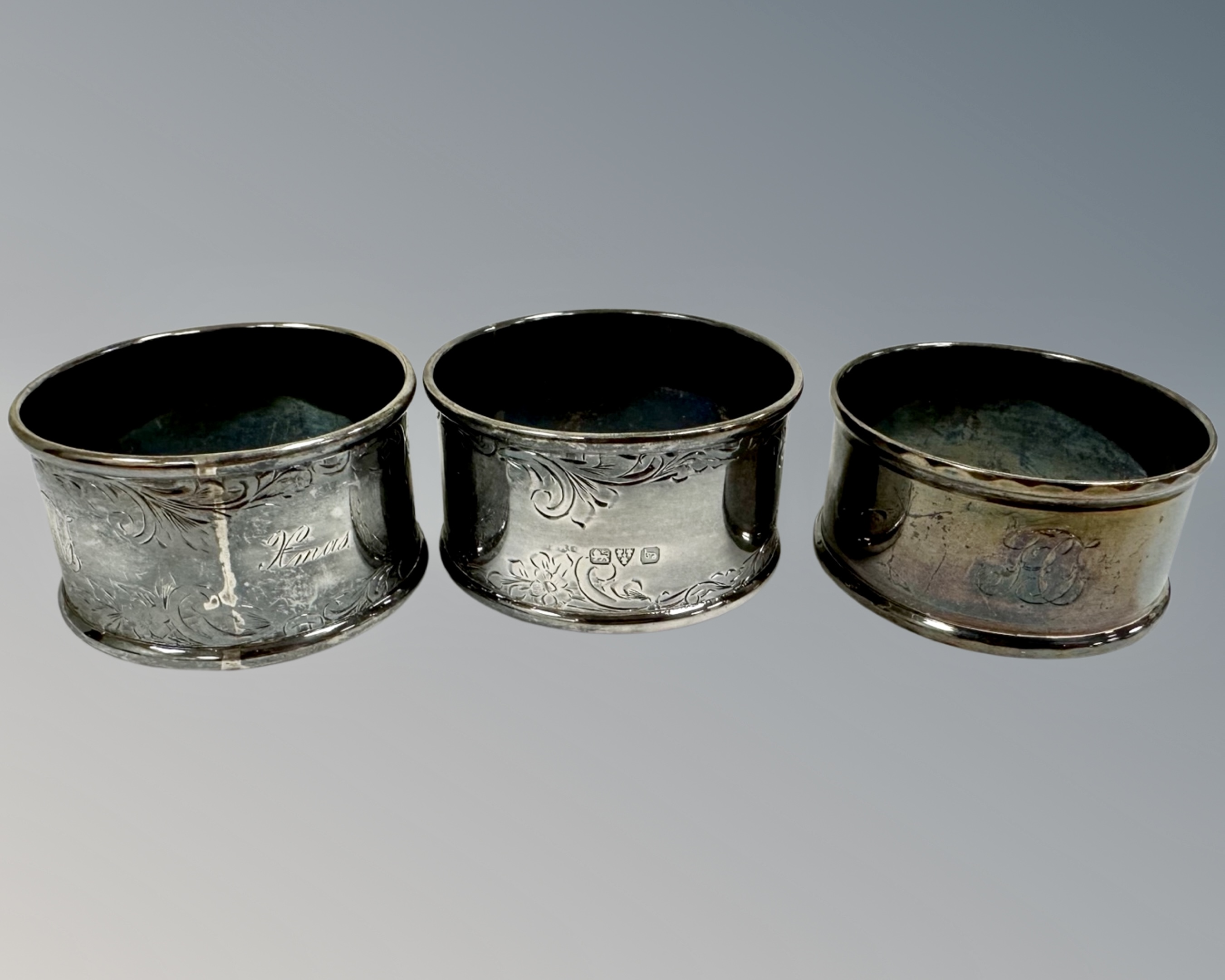 Three antique silver napkin rings.