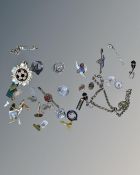 A collection of jewellery including silver badges,
