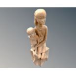 A pottery figure of a seated girl and boy.