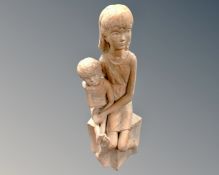 A pottery figure of a seated girl and boy.