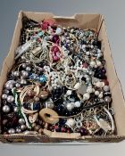 A box containing a large quantity of assorted costume jewellery, bead necklaces etc.