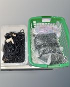 Two boxes containing assorted costume jewellery and beads.