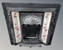 A tiled cast iron fire insert.