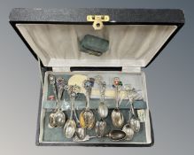 A box of assorted collector's teaspoons including silver examples.