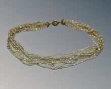 A seven strand pearl necklace with 18ct yellow gold clasp, length 43cm.
