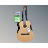 A Czech Strunal classical guitar in soft carry bag with guitar tuner and guitar books and