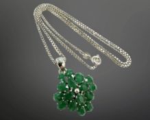 A silver emerald cluster pendant on chain, length 50cm, pendant 24mm diameter.