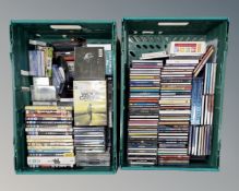 Two crates containing assorted DVDs and CDs.