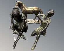 Two resin figures of seated ballerinas together with a similar figure of a horse.