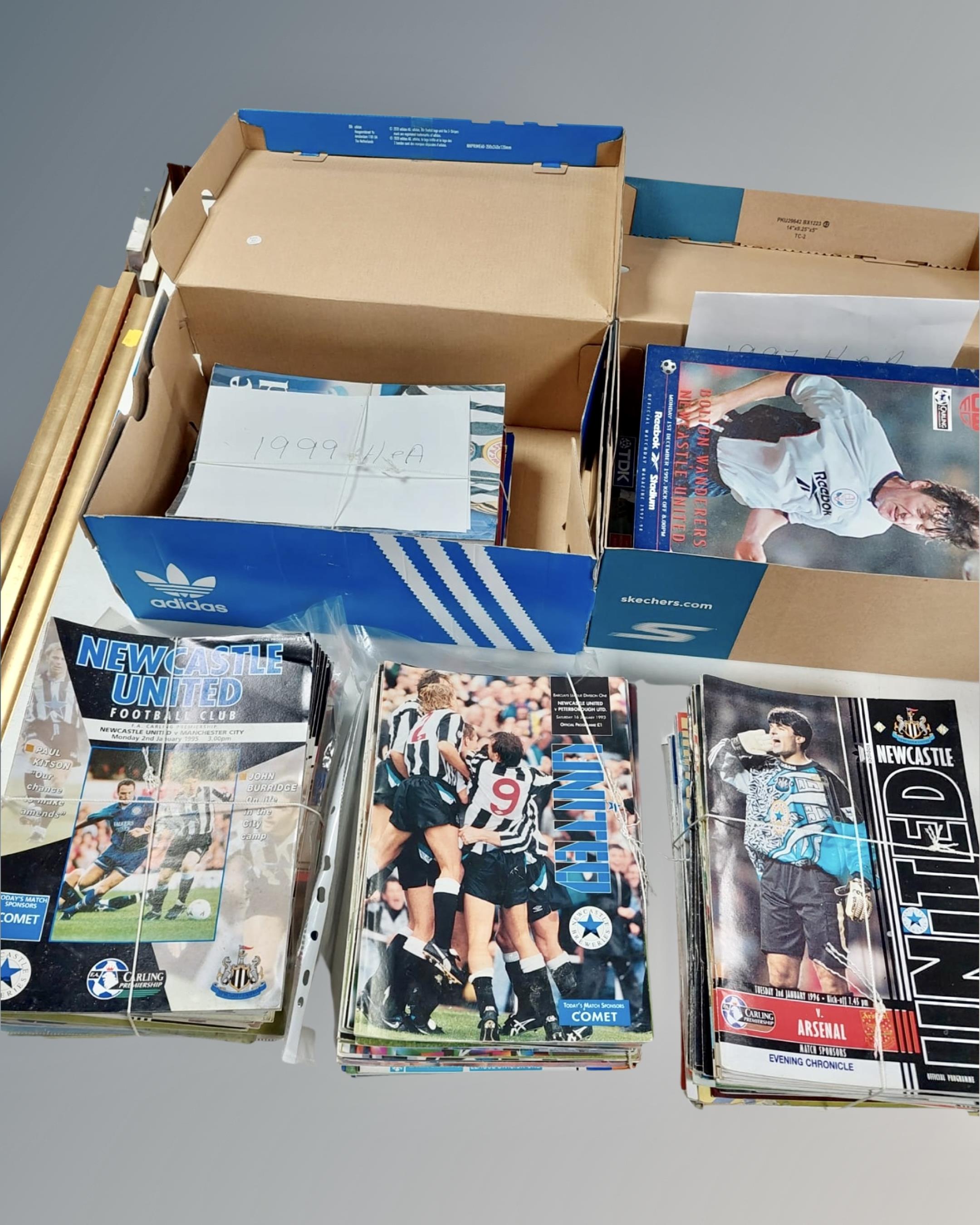 Three boxes containing a quantity of Newcastle United football programs.