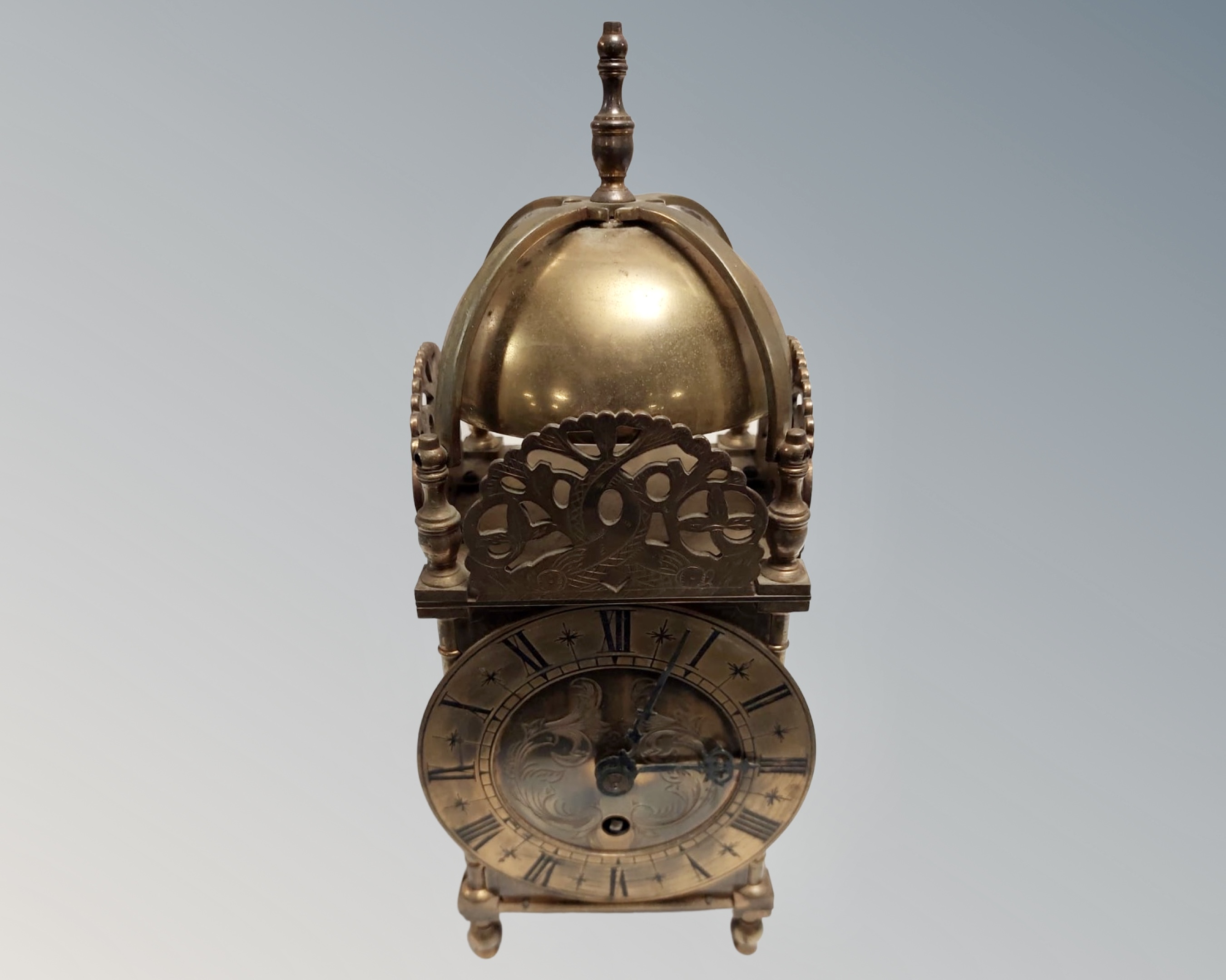 A brass lantern clock.