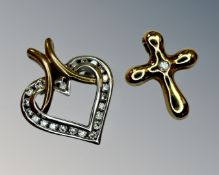 A gold heart pendant set with diamonds and a gold crucifix set with a diamond.