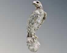 A carved alabaster figure of a perched eagle.