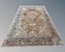 A machine-made carpet of Persian design, 349cm by 252cm.