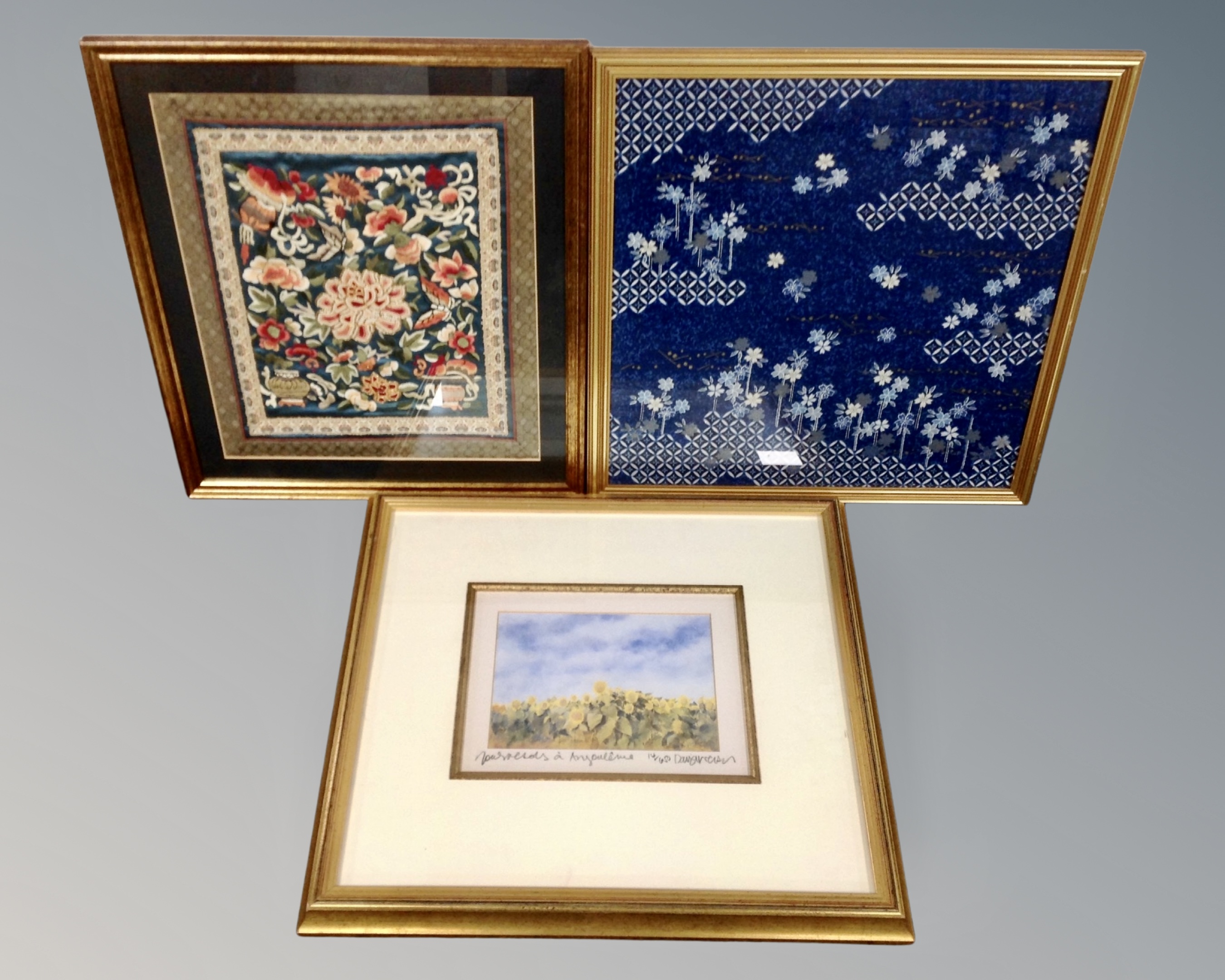 An Oriental framed silkwork embroidery together with two further pictures.