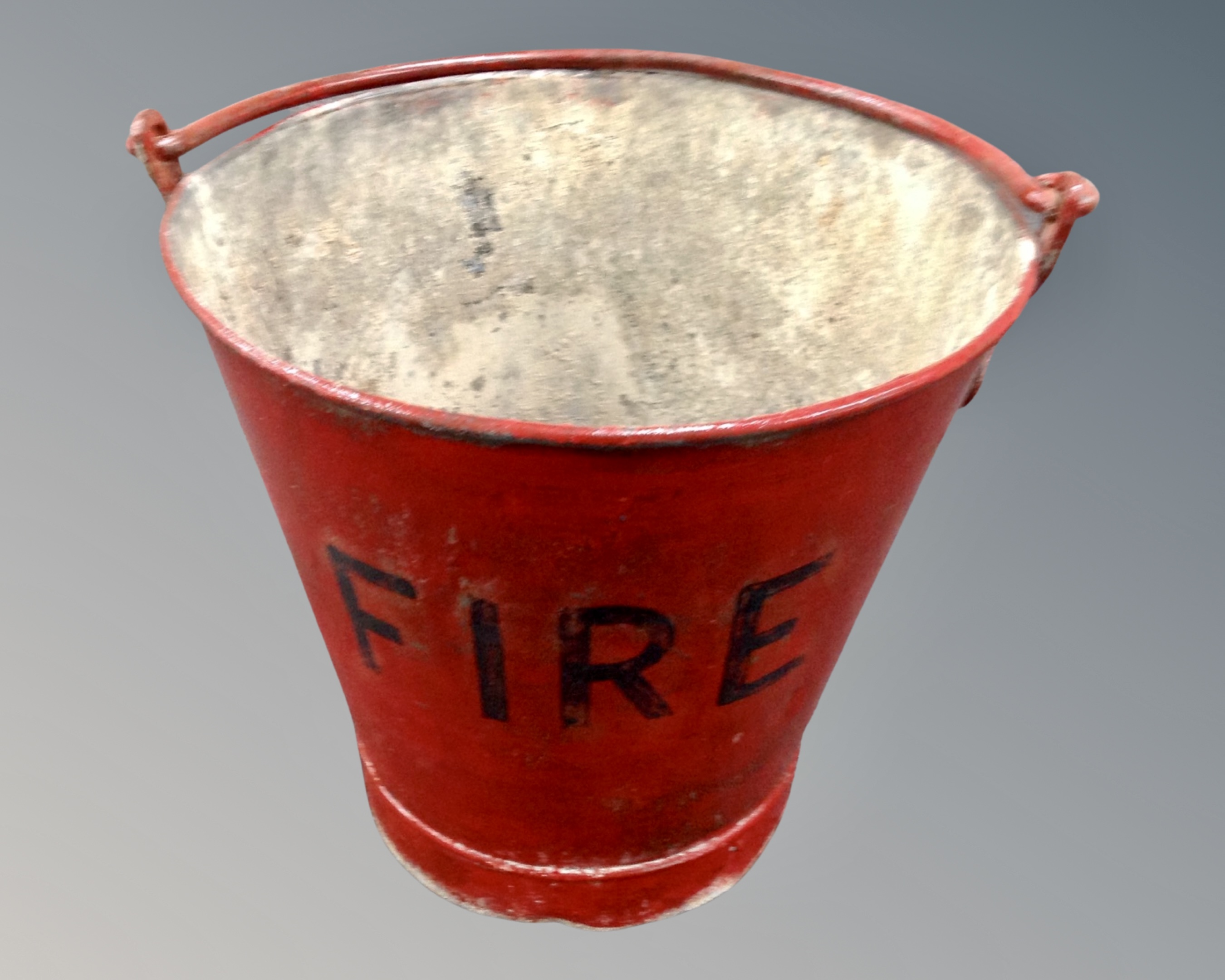 A painted metal fire bucket.
