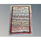An eastern polychrome rug, 117cm by 85cm.