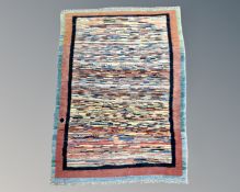 An eastern polychrome rug, 117cm by 85cm.