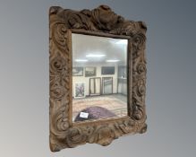 A carved oak framed mirror, 50cm by 66cm.