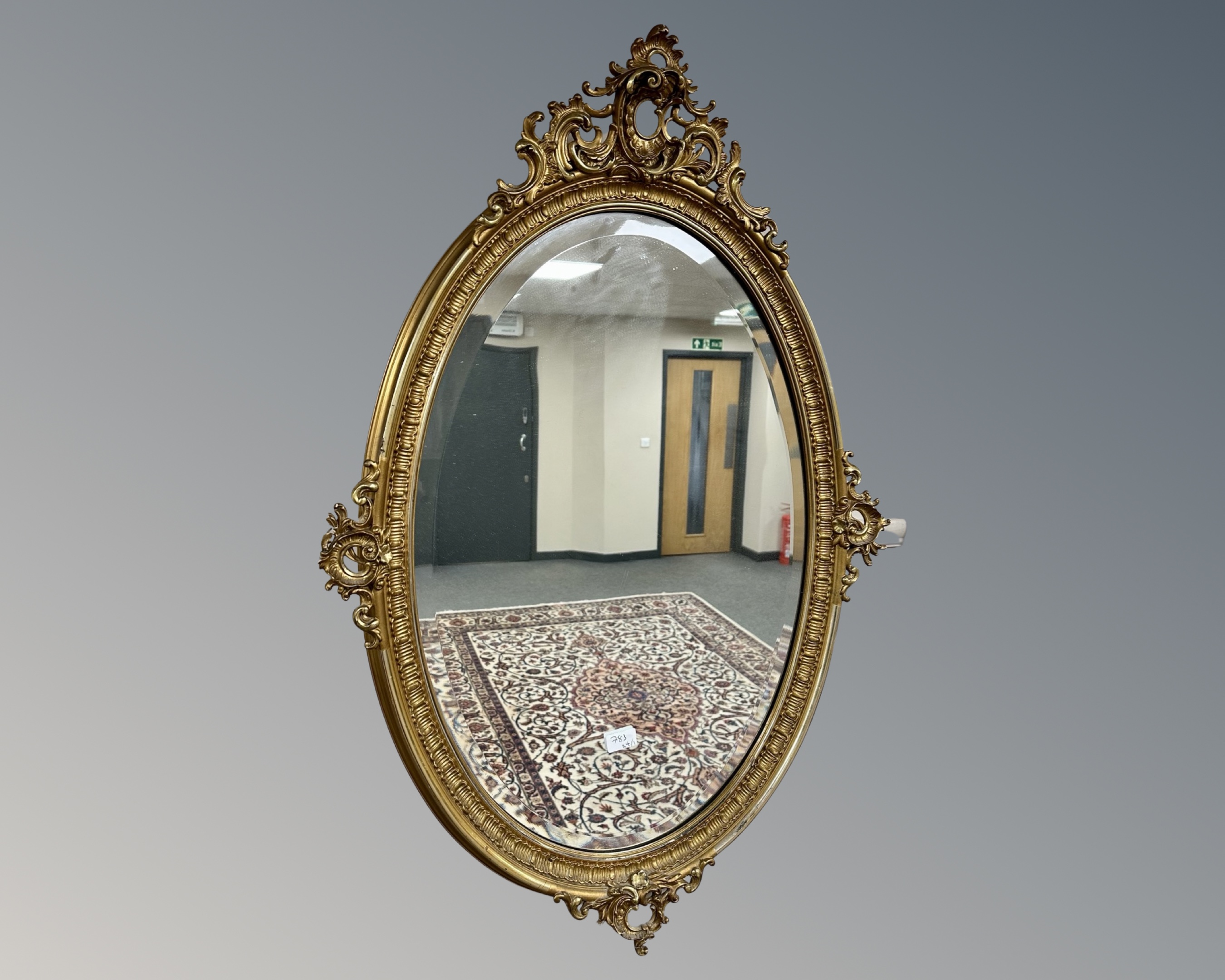A 19th century style oval gilt framed mirror, 105cm by 70cm.