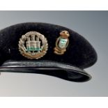 A military cap with Northamptonshire badge and one further cap badge.