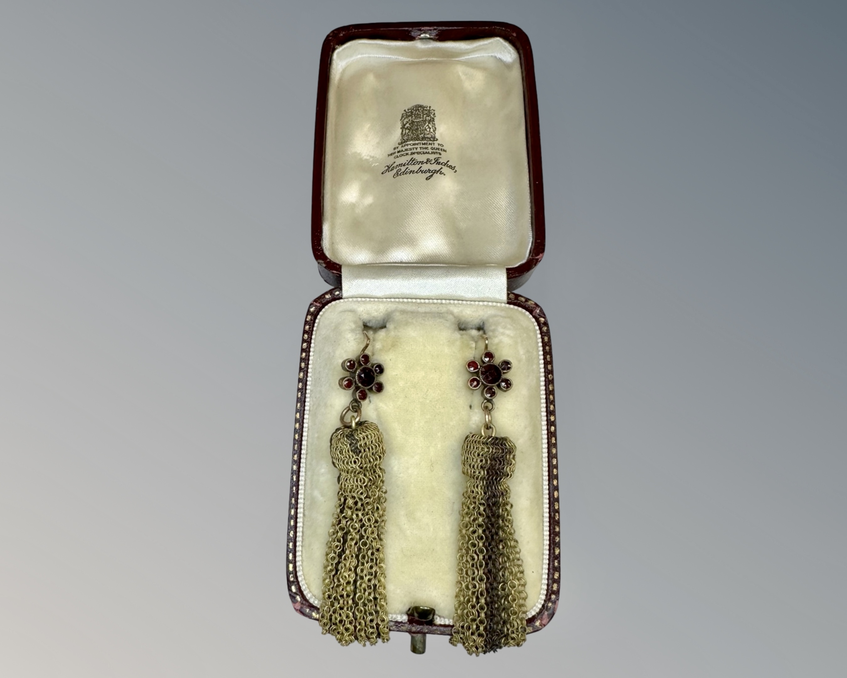 A cased pair of antique garnet earrings.