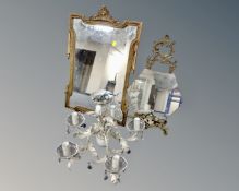 A gilt framed period style mirror together with a light fitting and a further mirror.