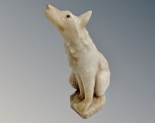 An alabaster figure of a seated wolf (height 32cm)