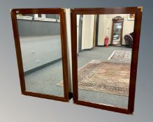 A pair of continental mahogany mirrors with brass corners, 81cm by 128cm.