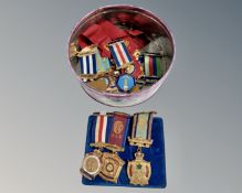 A tin containing approximately RAOB medals.