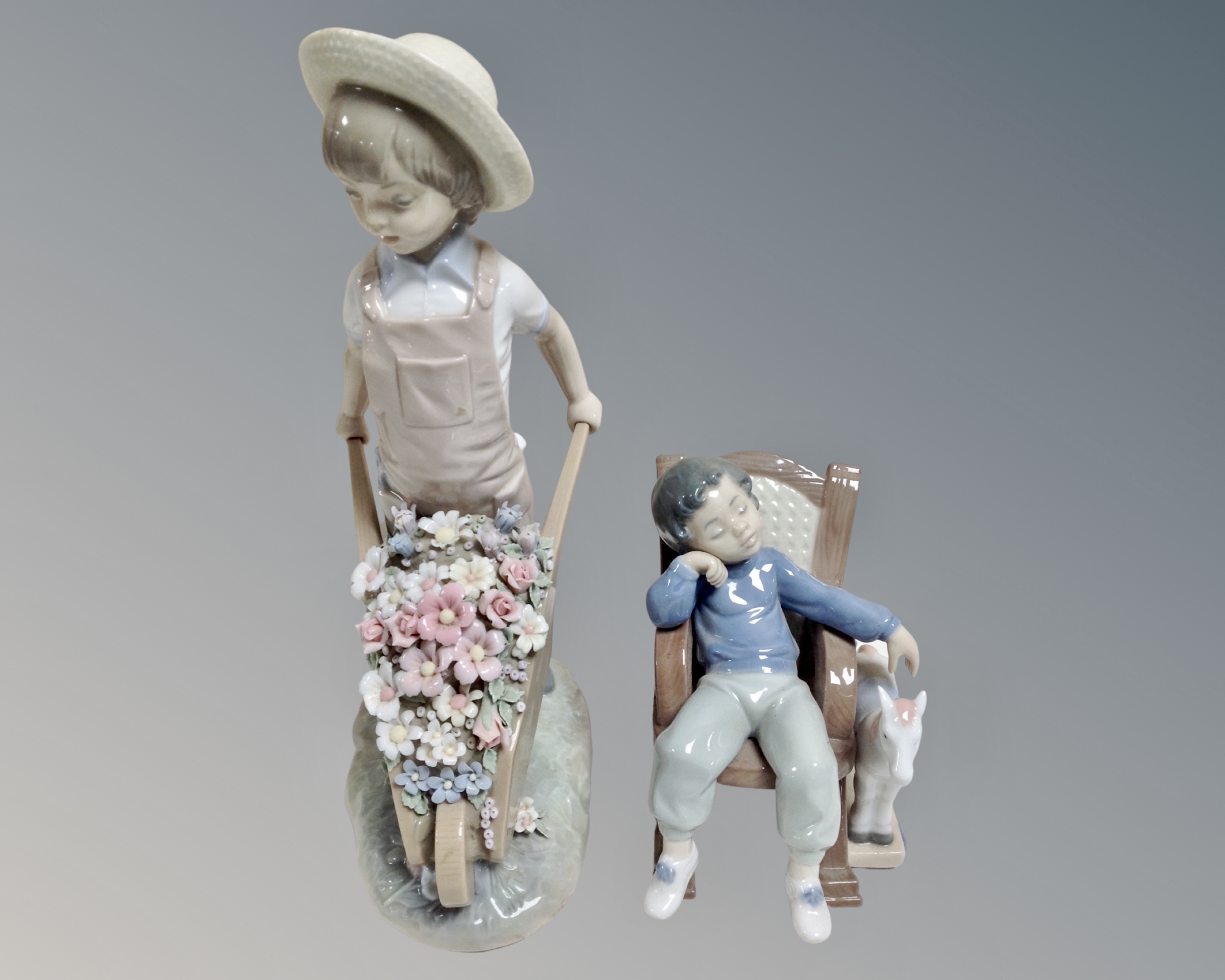 A Lladro figure number 1283 wheel barrow with flowers together with a further Lladro figure 5846