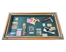 A reproduction football montage in glazed case.