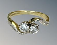 An antique 18ct yellow gold two stone diamond ring, with diamond shoulders, size J½,