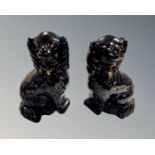 A pair of black glazed Staffordshire dogs.