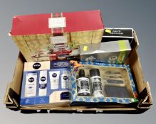 A box of cosmetic gift sets including Nivea Men, Ted Baker, David Beckham, a Yankee candle gift set.