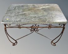 A wrought iron and green marble topped table