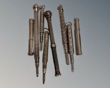 Eight silver and silver plate propelling pencils.