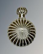 A silver scent bottle, height 5 cm x width 4 cm.