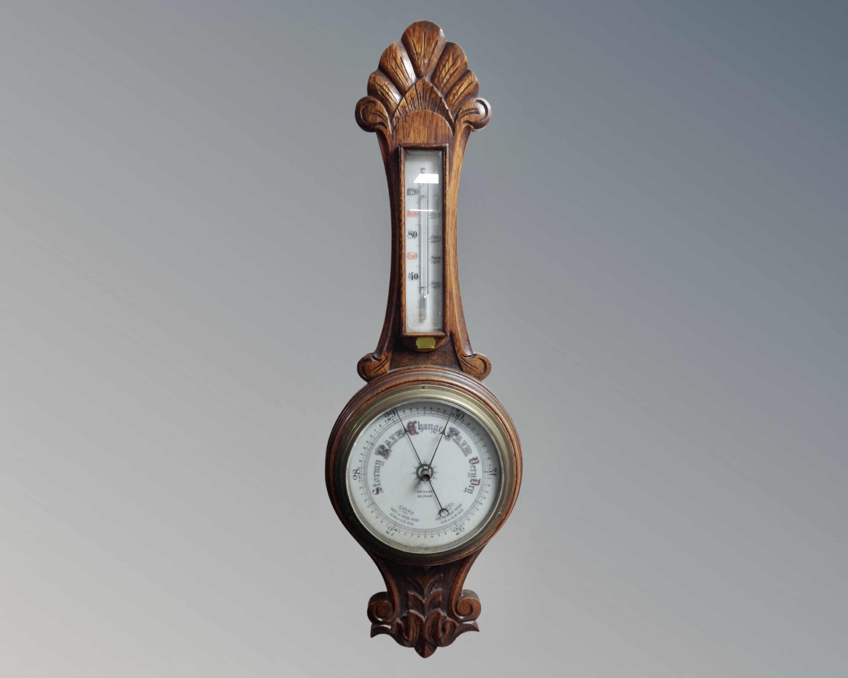 An Edwardian carved oak barometer