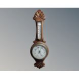 An Edwardian carved oak barometer