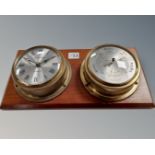 A clock and barometer mounted on board.