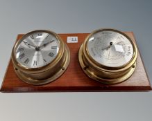 A clock and barometer mounted on board.