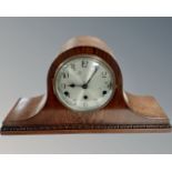 An Edwardian oak mantel clock with silvered dial.