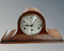 An Edwardian oak mantel clock with silvered dial.