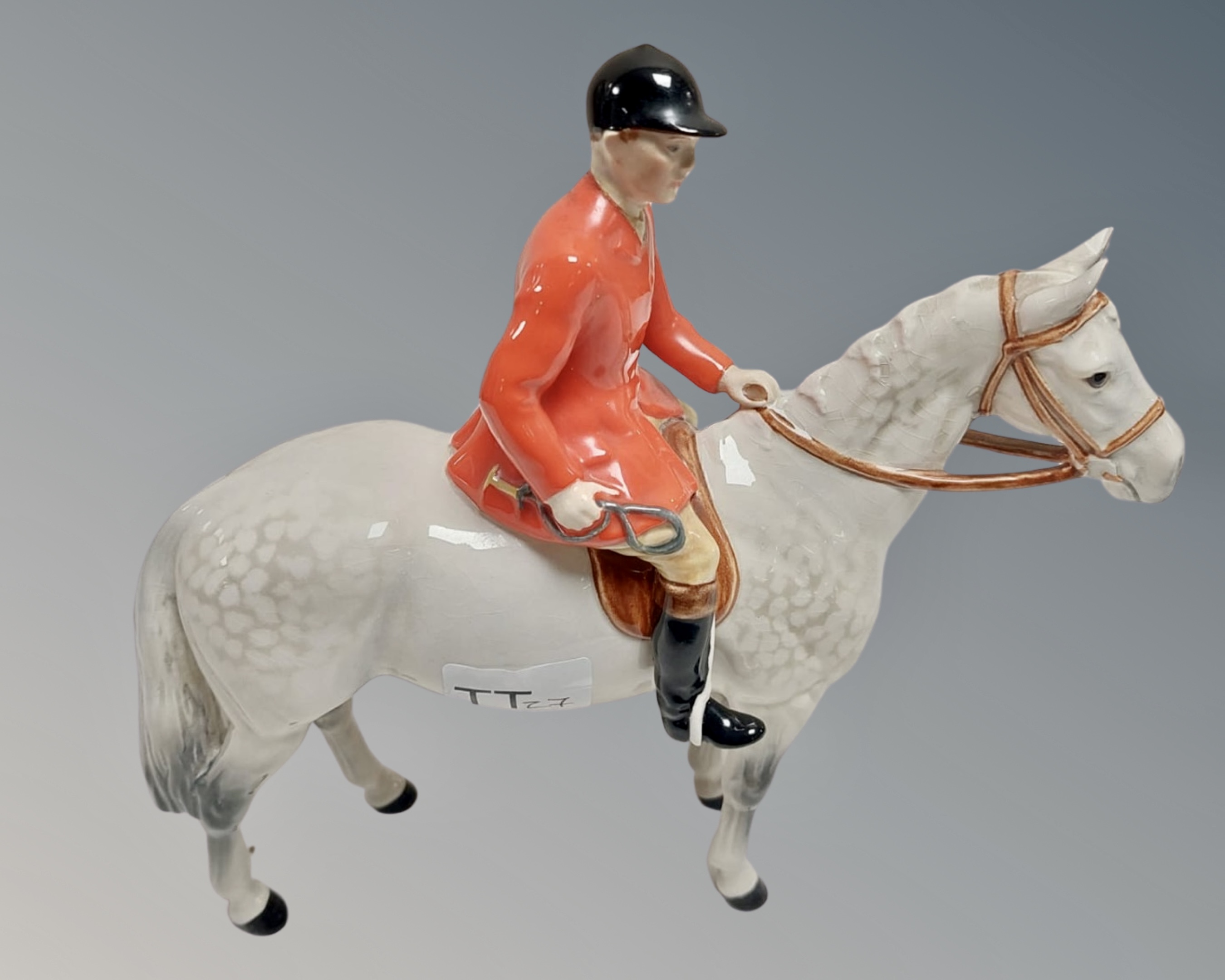 A Beswick figure of a huntsman on horseback.
