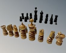 An antique stained wooden chess set, lacking one pawn,