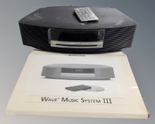 A Bose Wave music system III, with remote.