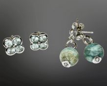 A pair of silver and topaz cluster earrings, and a further pair of silver drop earrings.