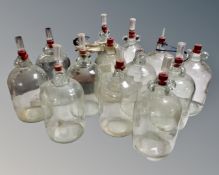 A collection of 14 assorted glass demijohns.